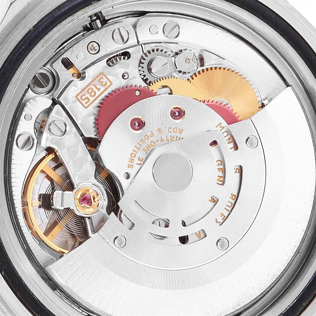 The image shows a close-up of the Rolex GMT-Master 16713 Men's Stainless Steel Brown Dial 16713 Men's Stainless Steel Brown Dial's movement, showcasing gears, the balance wheel, and rotor details.