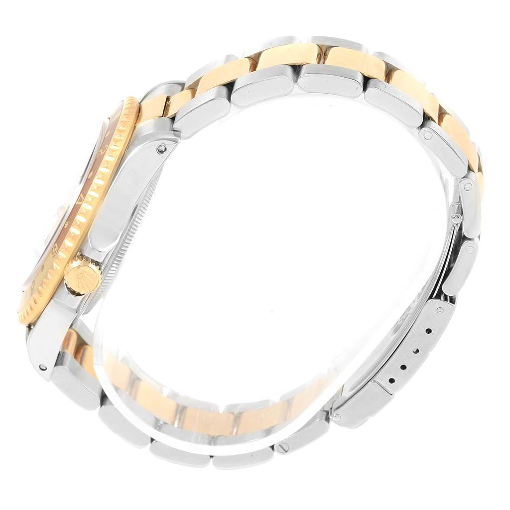 The image shows a side view of a Rolex GMT-Master 16713 Men's Stainless Steel Brown Dial 16713 Men's Stainless Steel Brown Dial watch, highlighting its two-tone bracelet and gold crown.