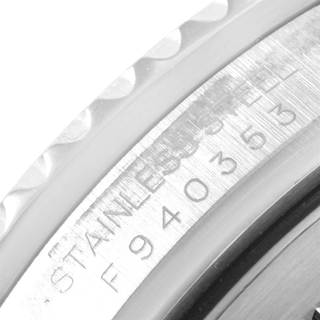 This image shows the engraved outer rim and serial number of a Rolex GMT-Master 16710 Men's Stainless Steel Black Dial 16710 Men's Stainless Steel Black Dial watch from a close-up angle.