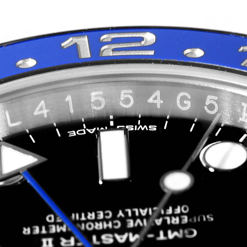 This close-up image of the Rolex GMT-Master 116710 Men's Stainless Steel Black Dial 116710 Men's Stainless Steel Black Dial shows the blue bezel, partial dial, and hour markers.