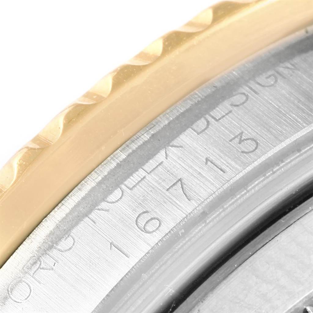 This close-up image shows part of the bezel and the inner case engraving of a Rolex GMT-Master 16713 Men's Steel and Gold (two tone) Champagne Dial 16713 Men's Steel and Gold (two tone) Champagne Dial watch.