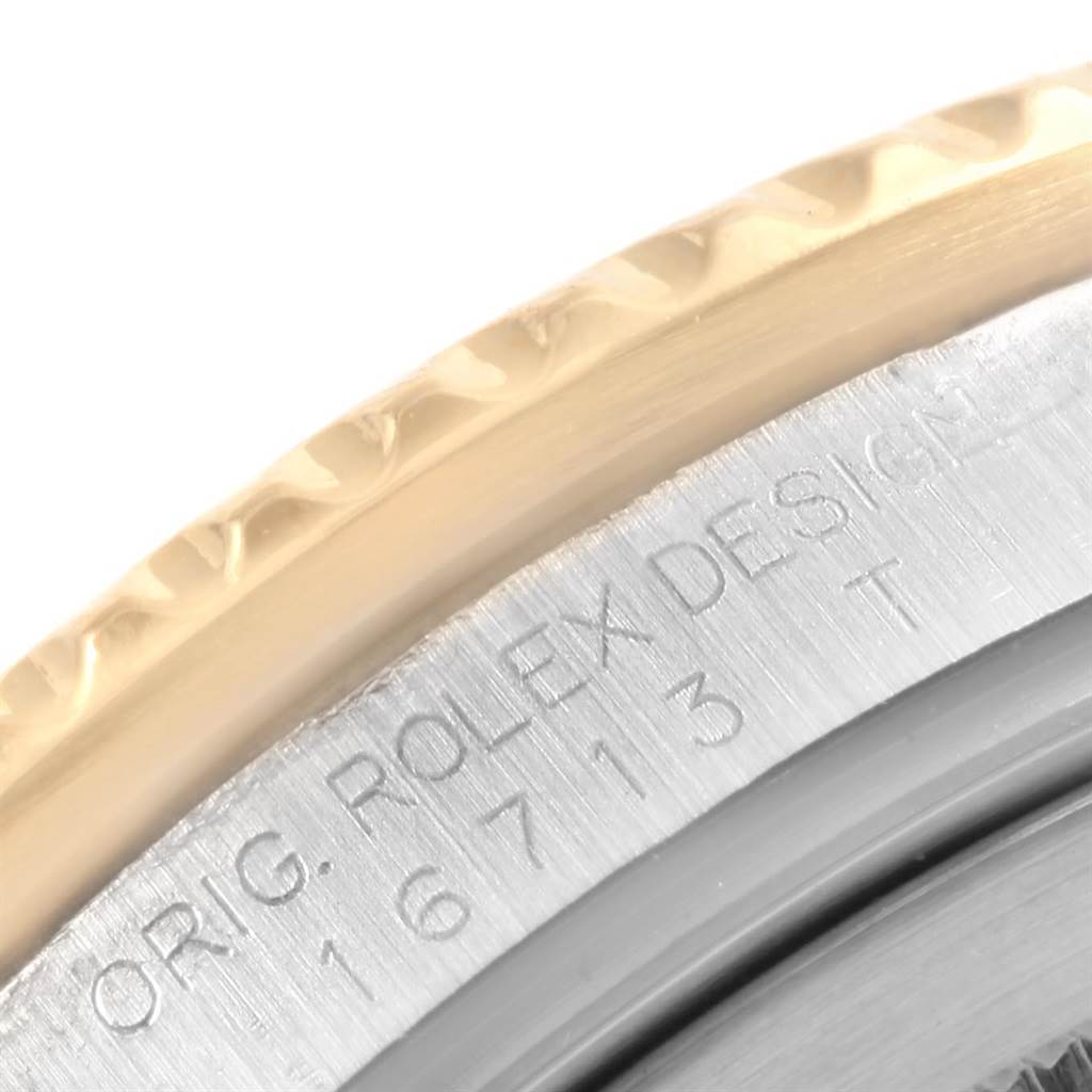 This close-up image shows the engraved outer rim and bezel of a Rolex GMT-Master 16713 Men's Stainless Steel Black Dial 16713 Men's Stainless Steel Black Dial watch.