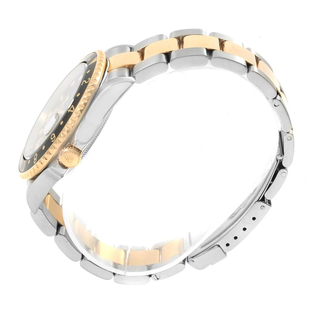 The Rolex GMT-Master 16713 Men's Stainless Steel Black Dial 16713 Men's Stainless Steel Black Dial watch is shown from a side angle, highlighting its bezel, crown, and two-tone bracelet.