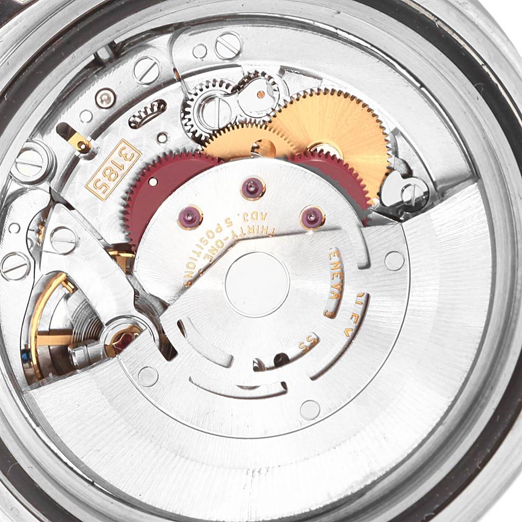 The image shows a close-up of the movement mechanism of a Rolex GMT-Master 16710 Men's Stainless Steel Black Dial 16710 Men's Stainless Steel Black Dial watch, highlighting gears and other internal components.
