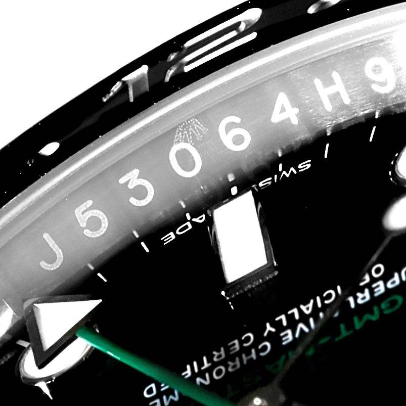 This close-up image shows the serial number and a portion of the GMT hand on a Rolex GMT-Master 116710 Men
s Stainless Steel Black Dial 116710 Men
s Stainless Steel Black Dial watch.