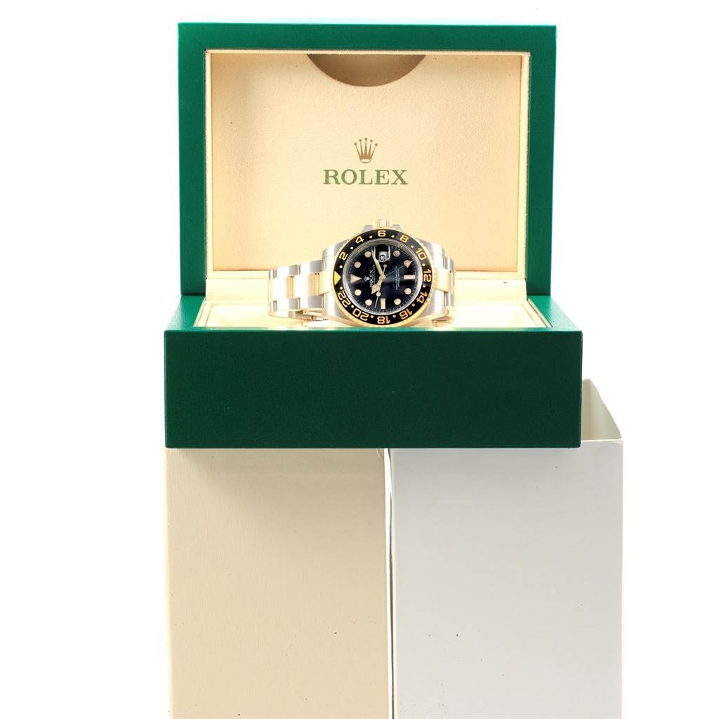 The Rolex GMT-Master 116713 Men's Stainless Steel Black Dial 116713 Men's Stainless Steel Black Dial watch is displayed front-facing in an open green and cream Rolex box.