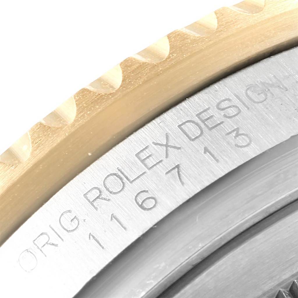 This close-up angle of the Rolex GMT-Master 116713 Men's Stainless Steel Black Dial 116713 Men's Stainless Steel Black Dial shows the edge of the bezel and engraved model information on the watch case.