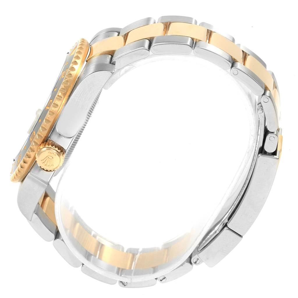 The image shows a side view of a Rolex GMT-Master 116713 Men's Stainless Steel Black Dial 116713 Men's Stainless Steel Black Dial watch, focusing on the two-tone bracelet and the crown.