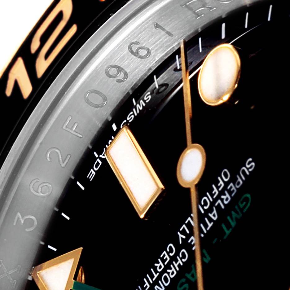 This close-up shows the dial, bezel with numbers, and hands of the Rolex GMT-Master 116713 Men's Stainless Steel Black Dial 116713 Men's Stainless Steel Black Dial watch.