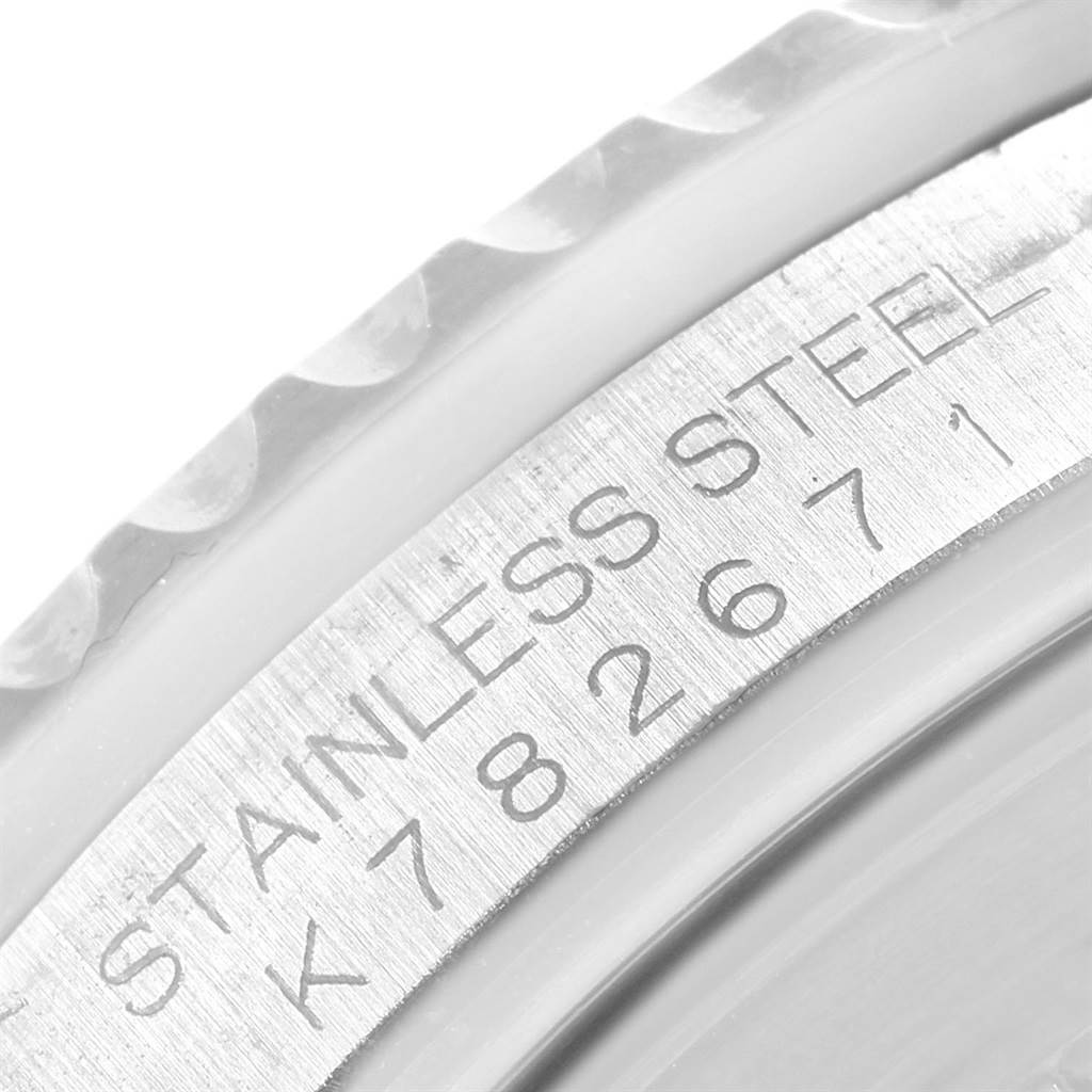 The image shows a close-up of the serial number and stainless steel engraving on the side of a Rolex GMT-Master 16710 Men's Stainless Steel Black Dial 16710 Men's Stainless Steel Black Dial watch case.