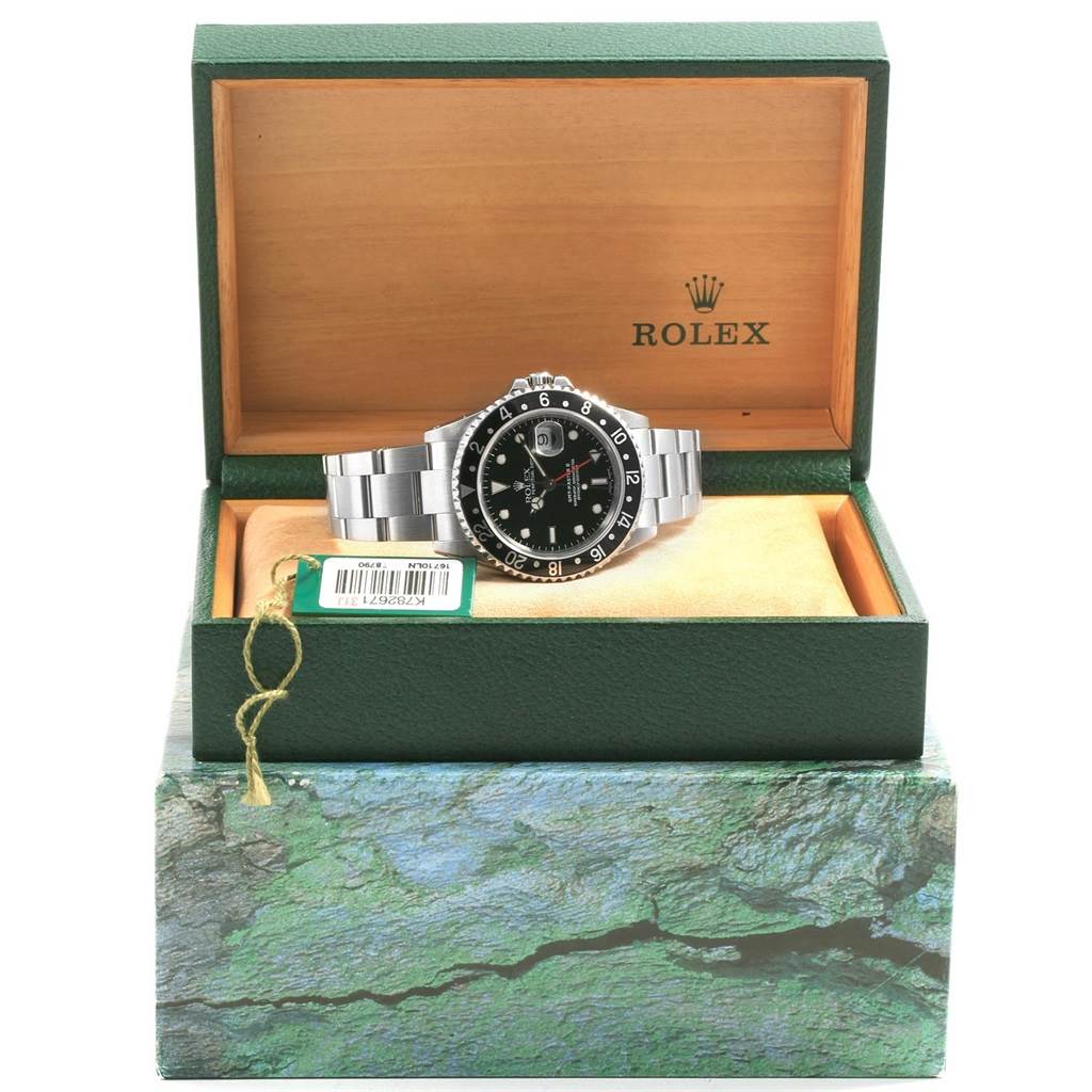 The Rolex GMT-Master 16710 Men's Stainless Steel Black Dial 16710 Men's Stainless Steel Black Dial watch is shown inside an open green and wood box, viewed from the front.