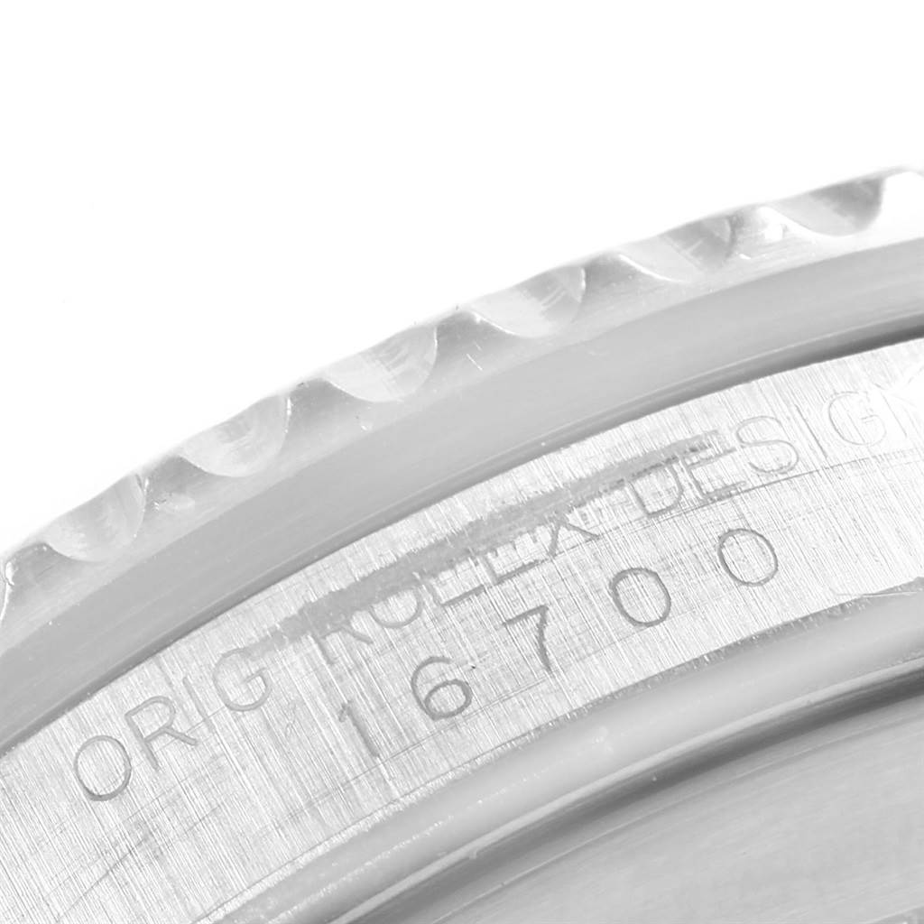 The image shows a close-up of the side of a Rolex GMT-Master 16700 Men's Stainless Steel Black Dial 16700 Men's Stainless Steel Black Dial watch, highlighting the bezel and engraved model number 16700.