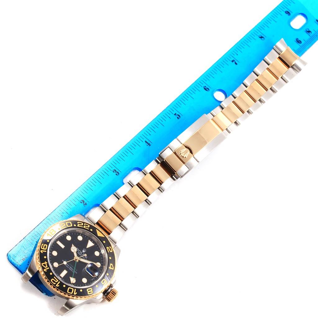 The image shows a Rolex GMT-Master 116713 Men's Stainless Steel Black Dial 116713 Men's Stainless Steel Black Dial watch laid flat next to a blue ruler, displaying its face, bezel, and bracelet.