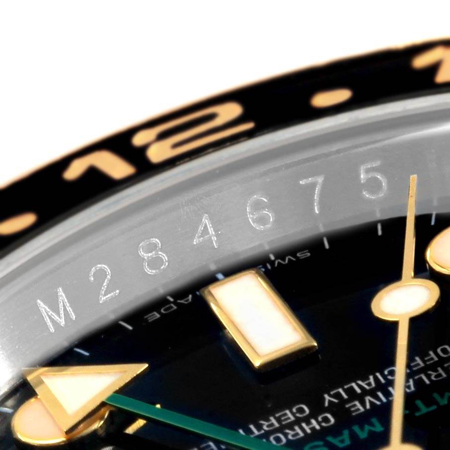 The image shows a close-up of the Rolex GMT-Master 116713 Men's Stainless Steel Black Dial 116713 Men's Stainless Steel Black Dial watch's face, focusing on the bezel, hour markers, and partially on the hands.