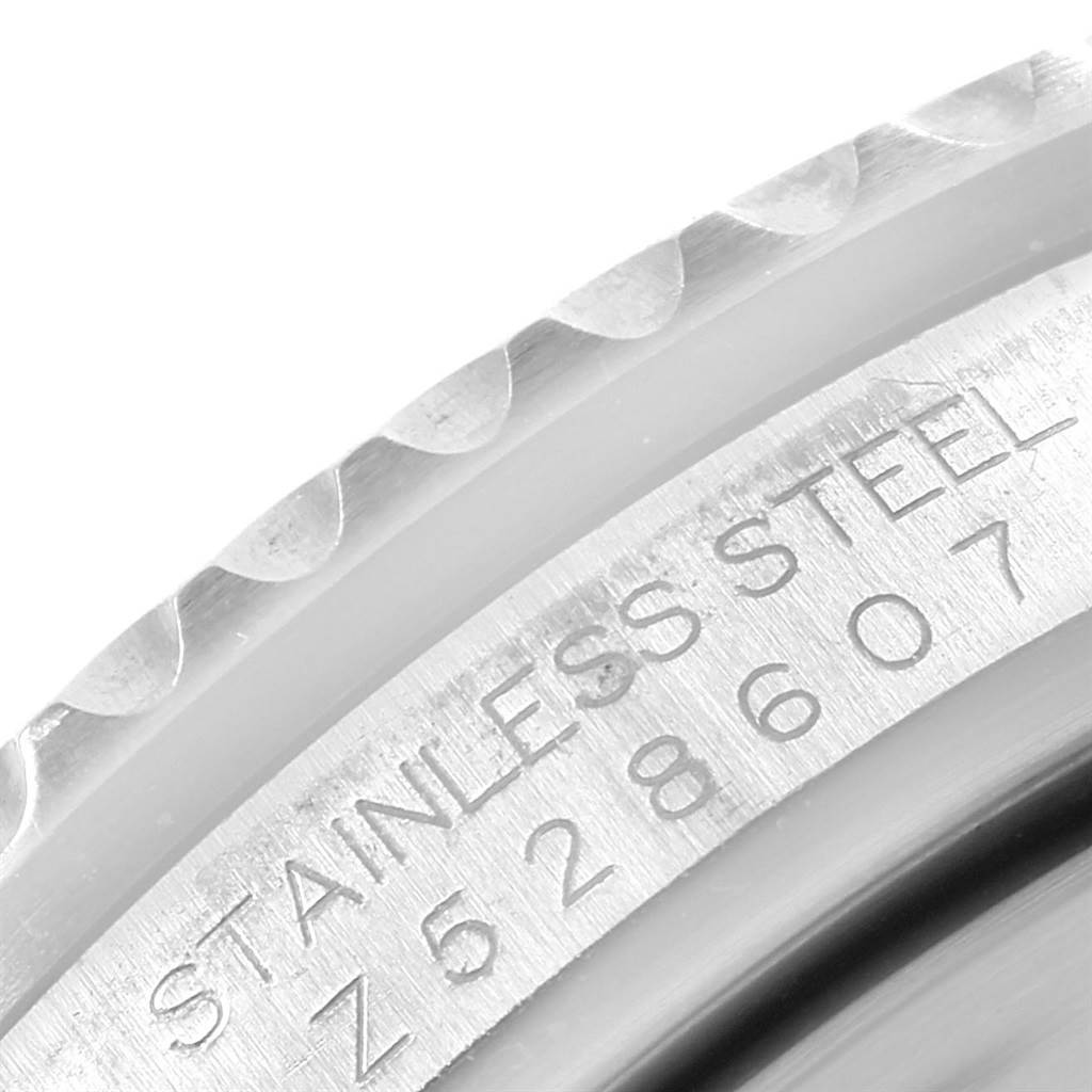 This close-up image shows the serial number and "STAINLESS STEEL" engraving on the case side of a Rolex GMT-Master 16710 Men's Stainless Steel Black Dial 16710 Men's Stainless Steel Black Dial watch.