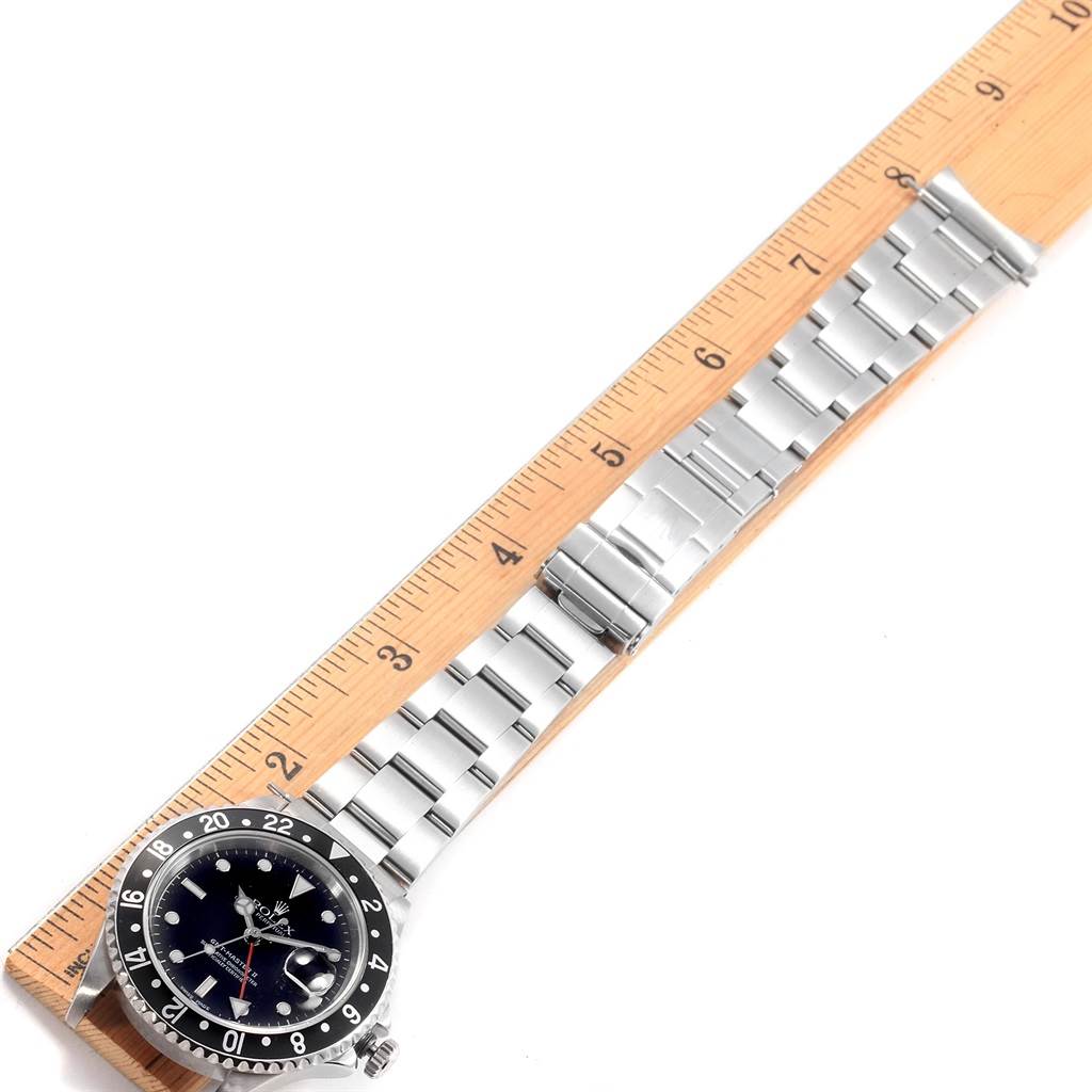 The image shows a Rolex GMT-Master 16710 Men's Stainless Steel Black Dial 16710 Men's Stainless Steel Black Dial watch with a stainless steel band placed next to a ruler for measurement.