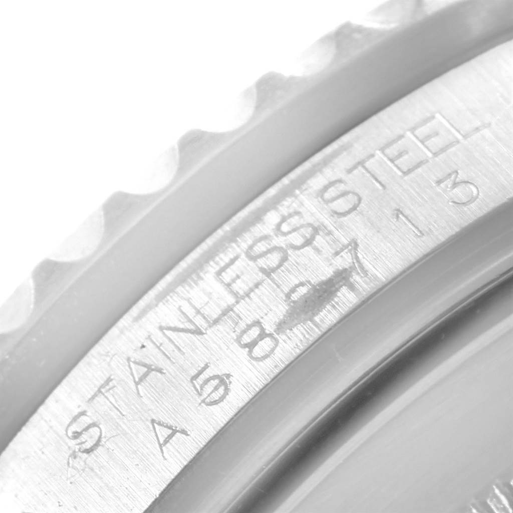 The image shows a close-up of the side of a Rolex GMT-Master 16710 Men's Stainless Steel Black Dial 16710 Men's Stainless Steel Black Dial watch, highlighting the serial number engravings on the stainless steel case.