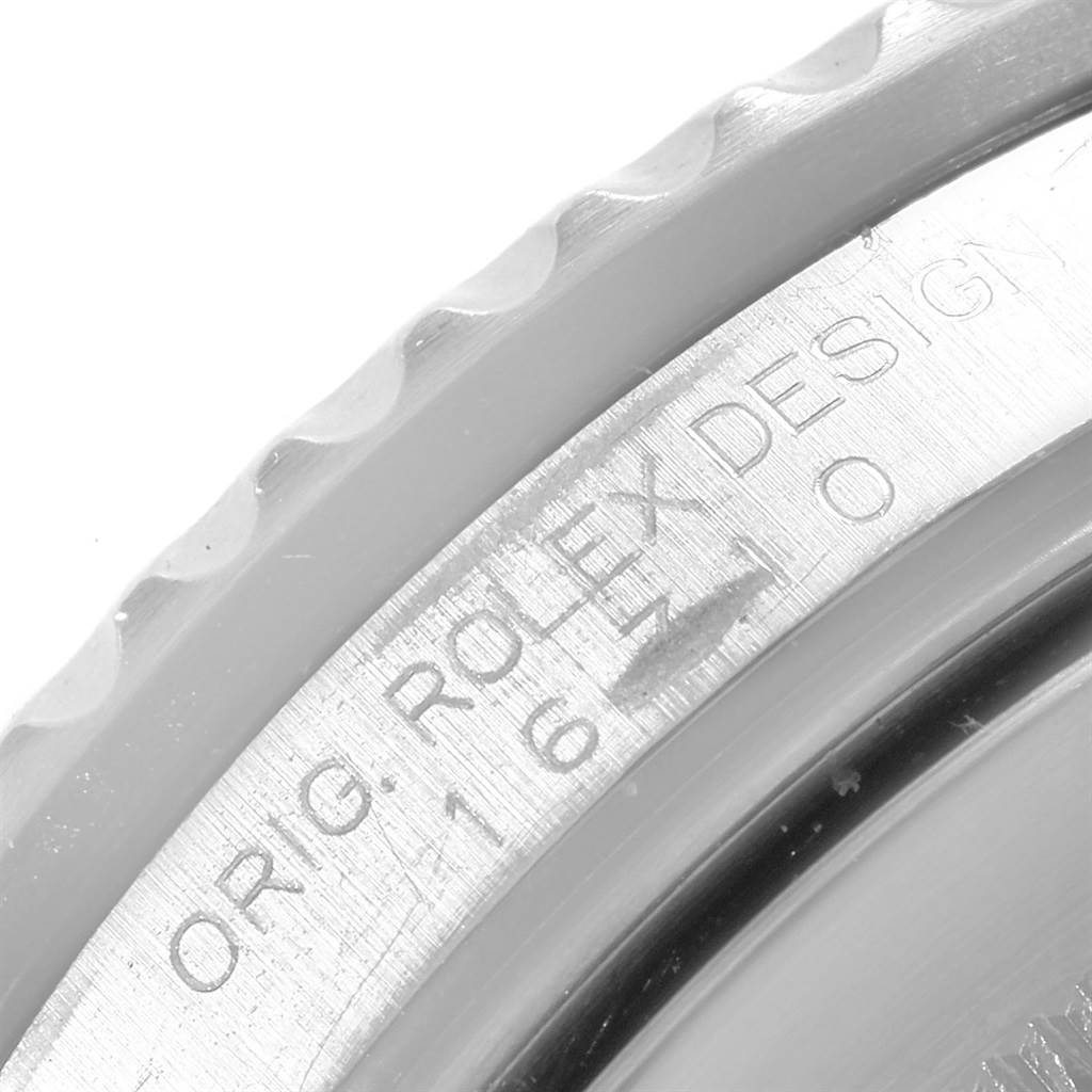 This close-up image shows the engraved bezel and case of a Rolex GMT-Master 16710 Men's Stainless Steel Black Dial 16710 Men's Stainless Steel Black Dial watch.