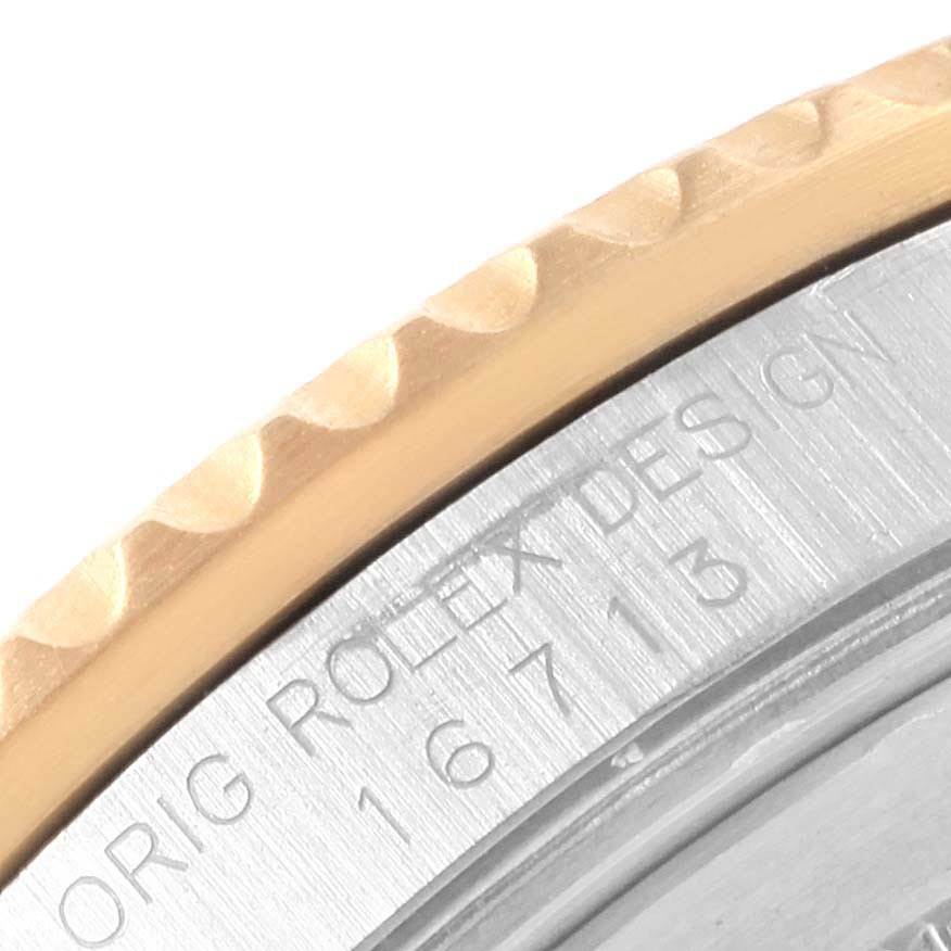 This close-up image of a Rolex GMT-Master 16713 Men's Stainless Steel Black Dial 16713 Men's Stainless Steel Black Dial shows part of the bezel and the engraved model number.