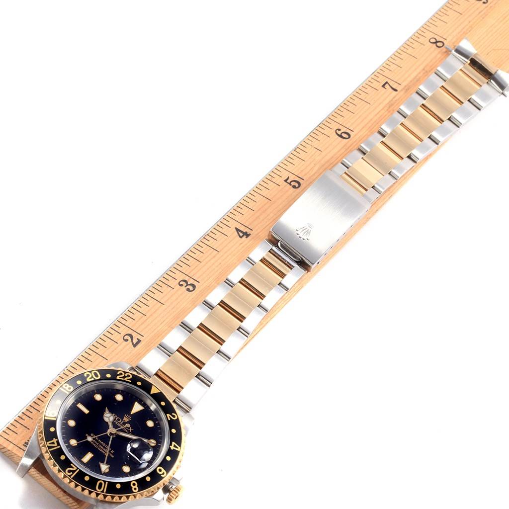 The image shows a Rolex GMT-Master 16713 Men's Stainless Steel Black Dial 16713 Men's Stainless Steel Black Dial watch lying flat, with the face and bracelet visible, measured by a wooden ruler.