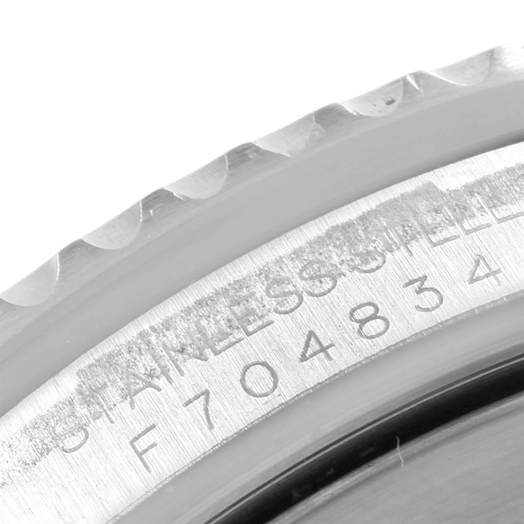 This image shows a close-up of the bezel and part of the case with the serial number for the Rolex GMT-Master 16710 Men's Stainless Steel Black Dial 16710 Men's Stainless Steel Black Dial watch.