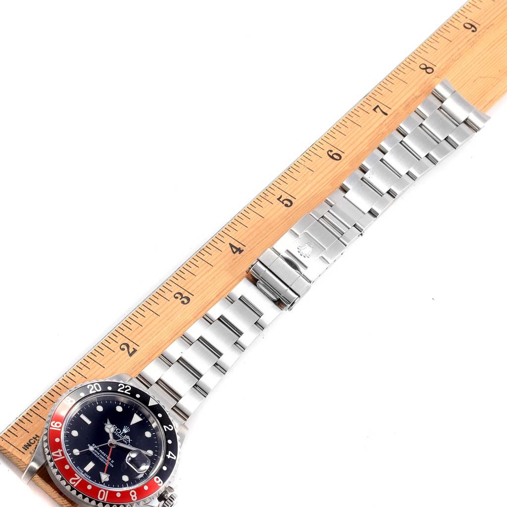 The image shows a top view of a Rolex GMT-Master 16710 Men's Stainless Steel Black Dial 16710 Men's Stainless Steel Black Dial watch, focusing on its bracelet and partially on its bezel and dial, with a ruler for scale.