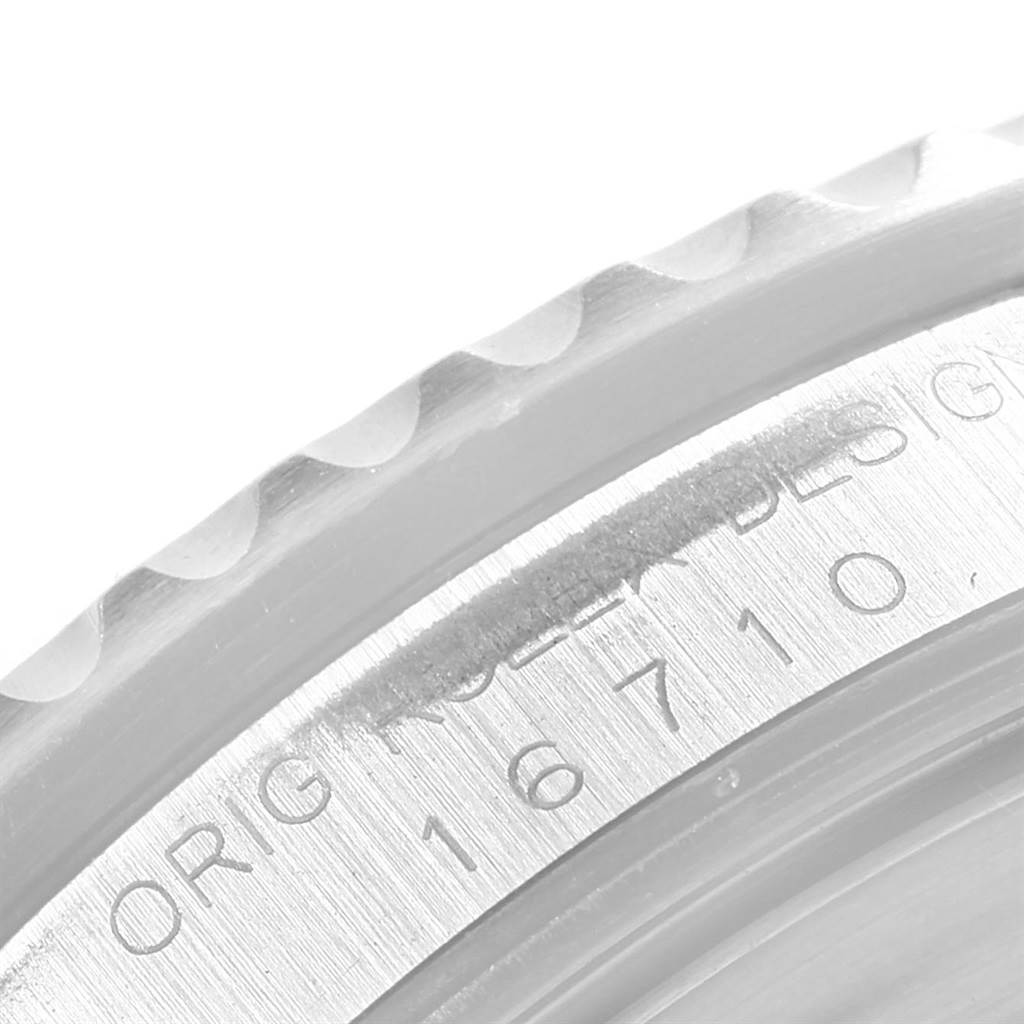 The image shows a close-up of the bezel and engraved caseback edge of a Rolex GMT-Master 16710 Men
s Stainless Steel Black Dial 16710 Men
s Stainless Steel Black Dial, displaying the model number 16710.