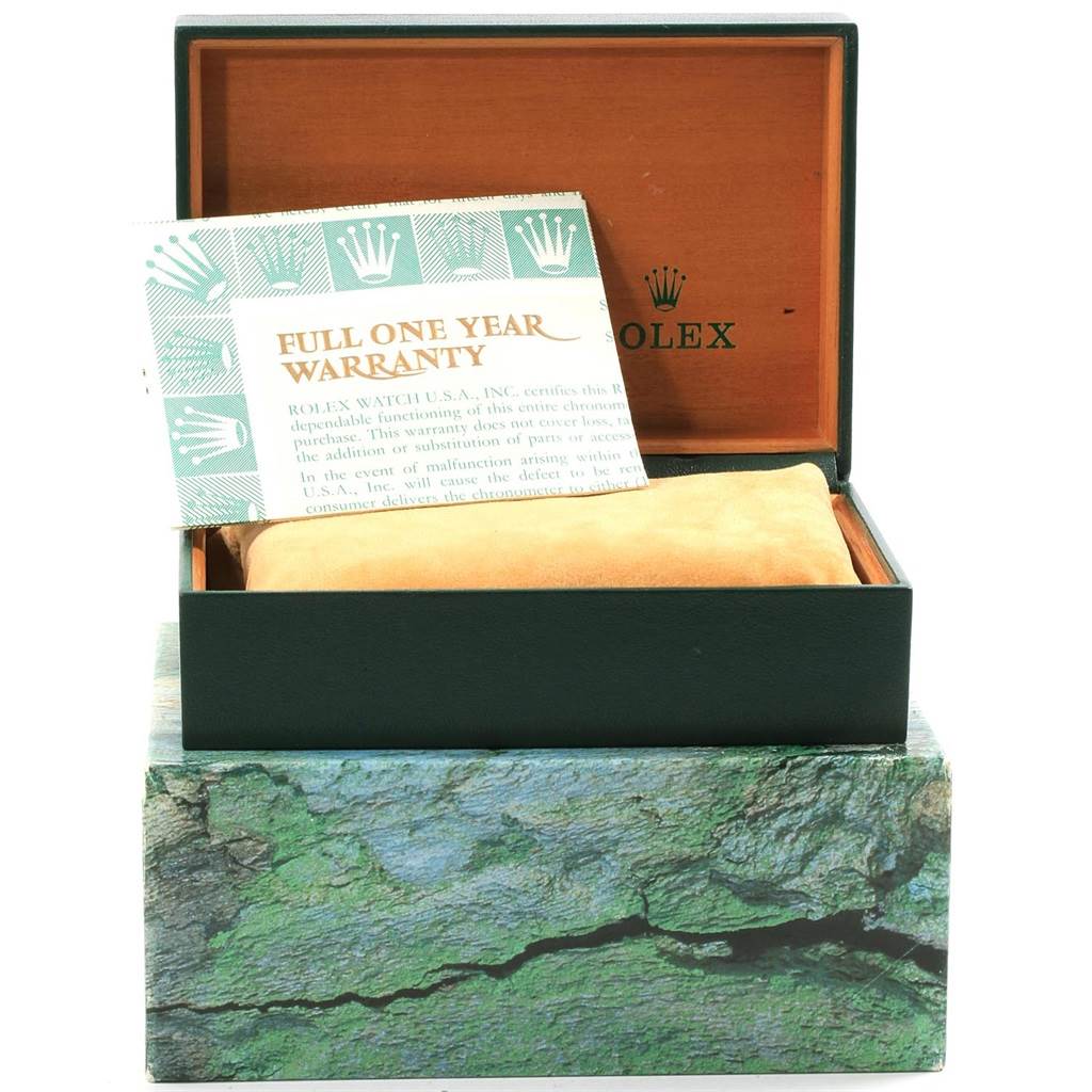 The image shows an open Rolex GMT-Master 16710 Men
s Stainless Steel Black Dial 16710 Men
s Stainless Steel Black Dial watch box with a warranty card and a cushion inside.