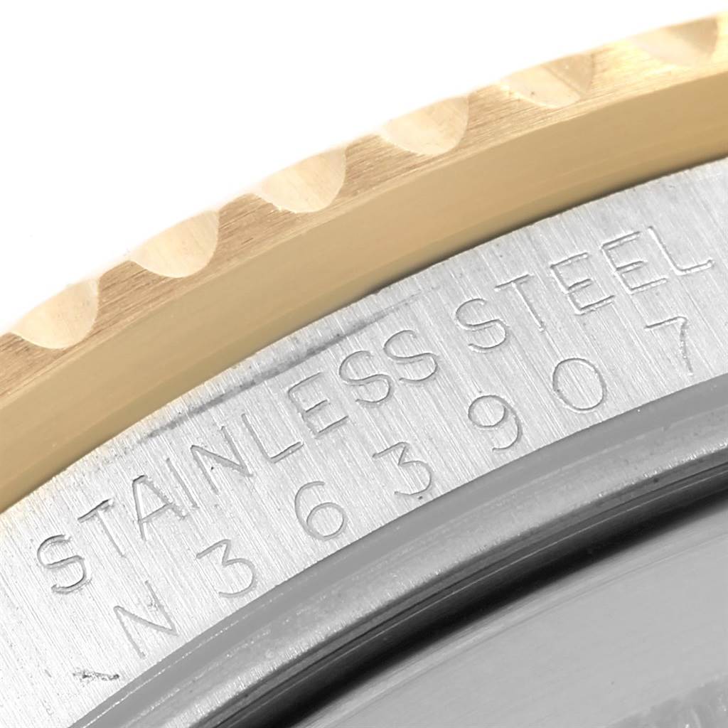The image shows a close-up of the edge and engraved serial number of a Rolex GMT-Master 16713 Men's Stainless Steel Black Dial 16713 Men's Stainless Steel Black Dial watch.