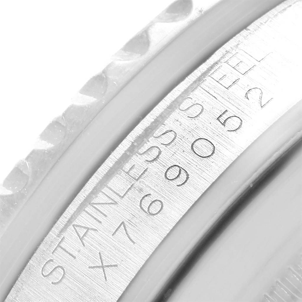 This image shows a close-up view of the bezel and part of the case of a Rolex GMT-Master 16700 Men's Stainless Steel Black Dial 16700 Men's Stainless Steel Black Dial watch, highlighting the stainless steel and serial engraving.