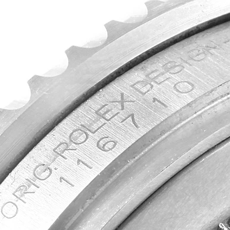 This close-up image displays the engraved bezel and case edge of a Rolex GMT-Master 116710 Men's Stainless Steel Black Dial 116710 Men's Stainless Steel Black Dial watch.