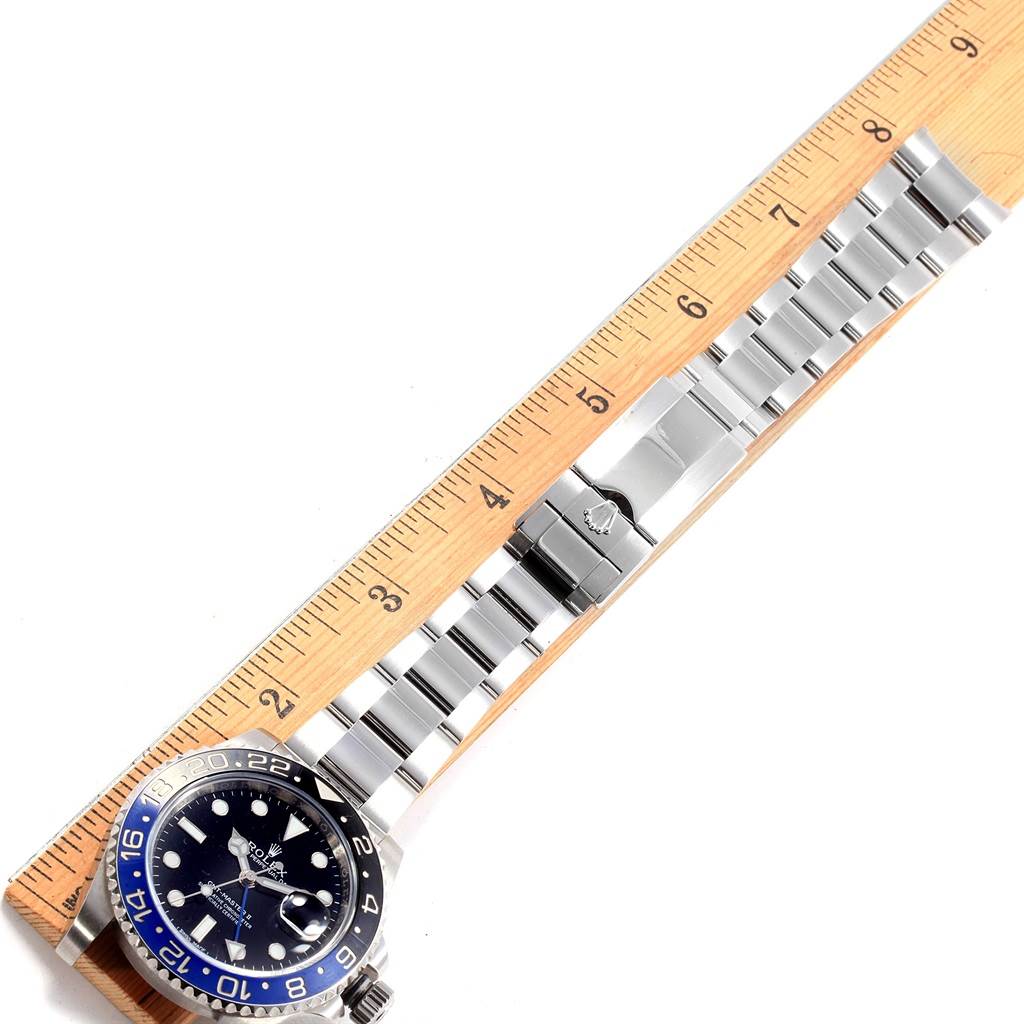 The image shows a Rolex GMT-Master 116710 Men's Stainless Steel Black Dial 116710 Men's Stainless Steel Black Dial watch laid flat alongside a ruler, highlighting the dial, bezel, and bracelet.
