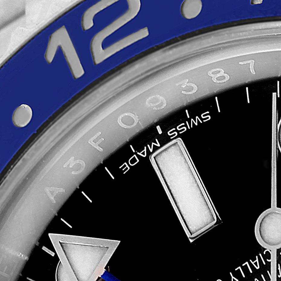 This image shows a close-up of the Rolex GMT-Master 116710 Men's Stainless Steel Black Dial 116710 Men's Stainless Steel Black Dial watch, focusing on the bezel, partial dial, and the Swiss Made mark.