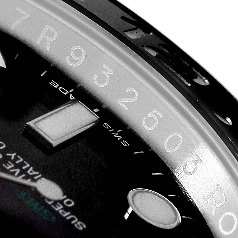 The image shows a close-up of the face and bezel of a Rolex GMT-Master 116710 Men's Stainless Steel Black Dial 116710 Men's Stainless Steel Black Dial watch, highlighting the hour markers and partial serial number.