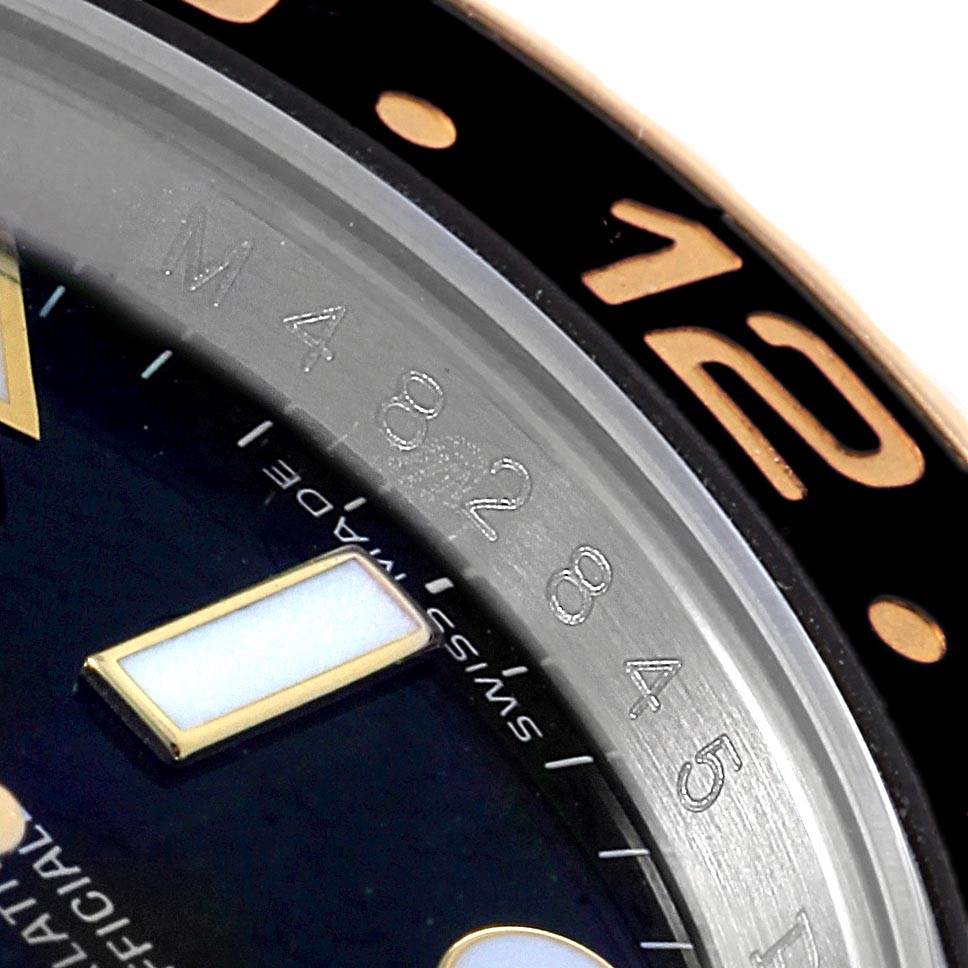 This image shows a close-up of the bezel and dial of the Rolex GMT-Master 116713 Men's Stainless Steel Black Dial 116713 Men's Stainless Steel Black Dial, highlighting the 12 o'clock marker.