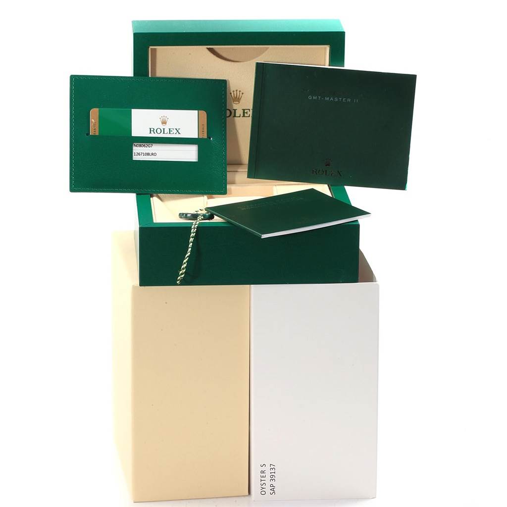 The image shows the packaging, warranty card, and manuals for a Rolex GMT-Master 126710 Men's Stainless Steel Black Dial 126710 Men's Stainless Steel Black Dial watch.