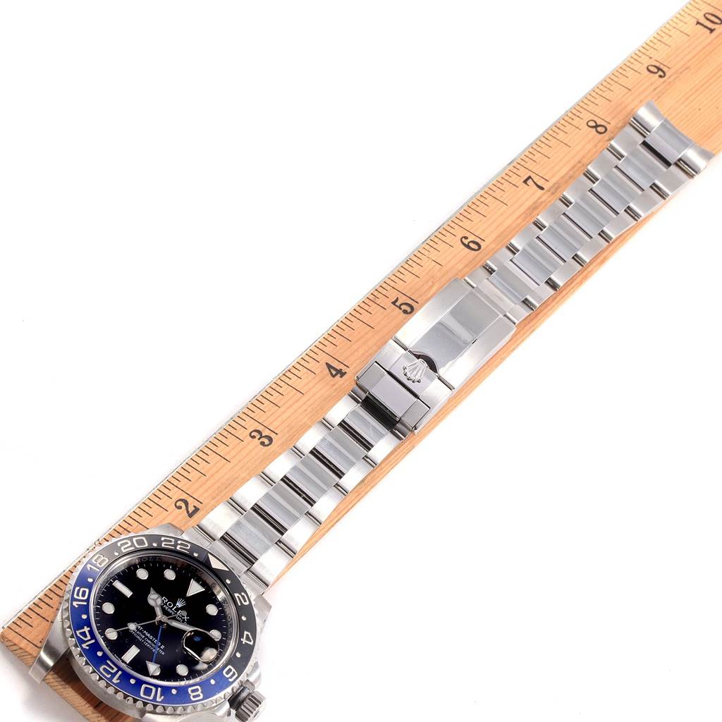 The image shows a top-down view of a Rolex GMT-Master 116710 Men's Stainless Steel Black Dial 116710 Men's Stainless Steel Black Dial watch, displaying its face, bezel, and bracelet laid alongside a ruler.