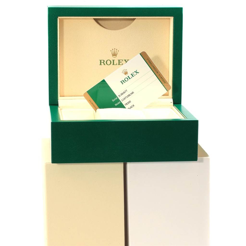 This image shows an open green Rolex box with a GMT-Master model warranty card inside.