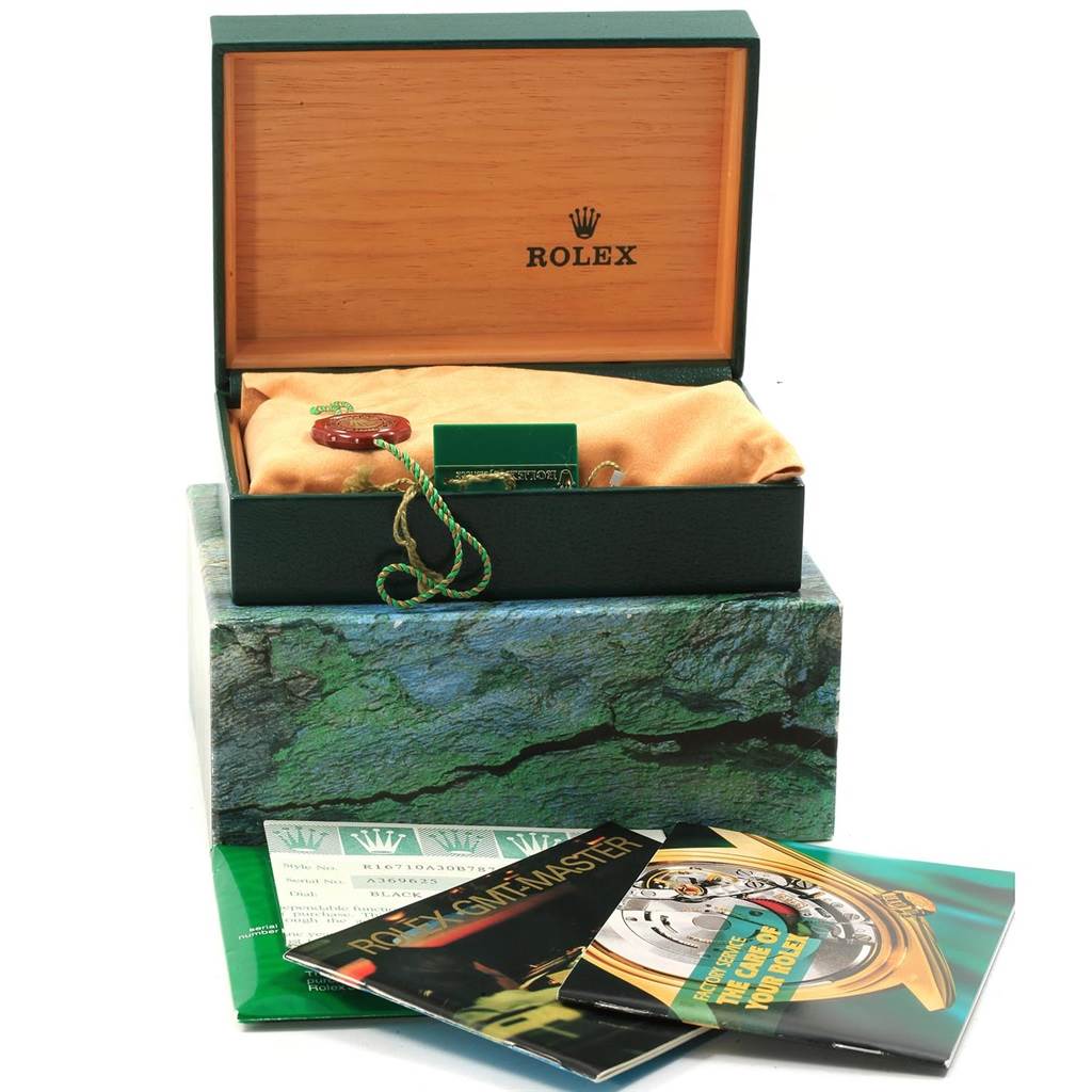 This image shows the open box of a Rolex GMT-Master 16710 Men's Stainless Steel Black Dial 16710 Men's Stainless Steel Black Dial, along with its accessories and documentation.