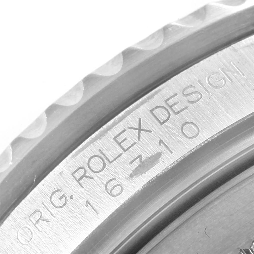 This image shows a close-up of the engraved case side of a Rolex GMT-Master 16710 Men's Stainless Steel Black Dial 16710 Men's Stainless Steel Black Dial watch.