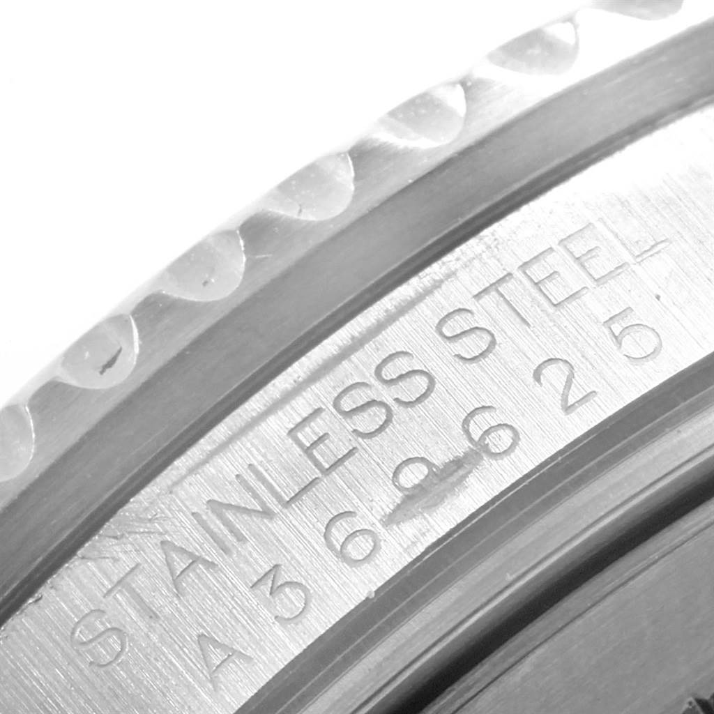 This image shows a close-up angle of the bezel and engraved stainless steel case of a Rolex GMT-Master 16710 Men's Stainless Steel Black Dial 16710 Men's Stainless Steel Black Dial watch.