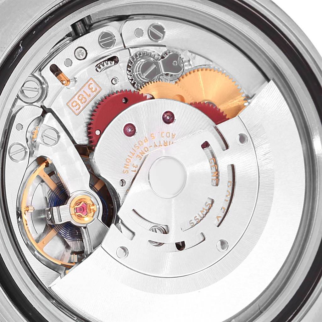 The image shows a close-up view of the mechanical movement inside a Rolex GMT-Master 116713 Men's Stainless Steel Black Dial 116713 Men's Stainless Steel Black Dial, highlighting its gears and intricate components.