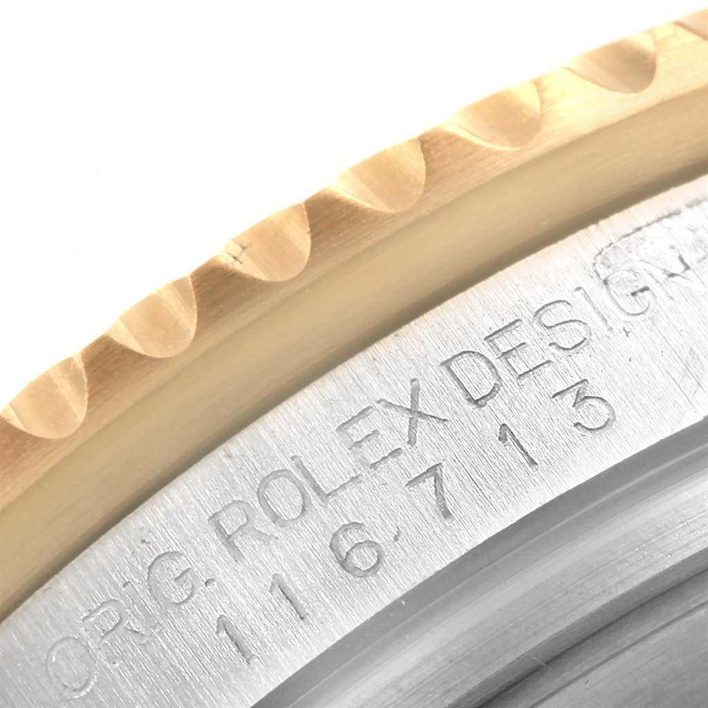 This close-up image shows the engraved reference number on the case and part of the bezel of a Rolex GMT-Master 116713 Men's Stainless Steel Black Dial 116713 Men's Stainless Steel Black Dial watch.