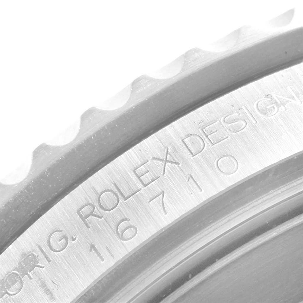 The image shows a close-up of the engraved bezel and case of a Rolex GMT-Master 16710 Men's Stainless Steel Black Dial 16710 Men's Stainless Steel Black Dial model watch.