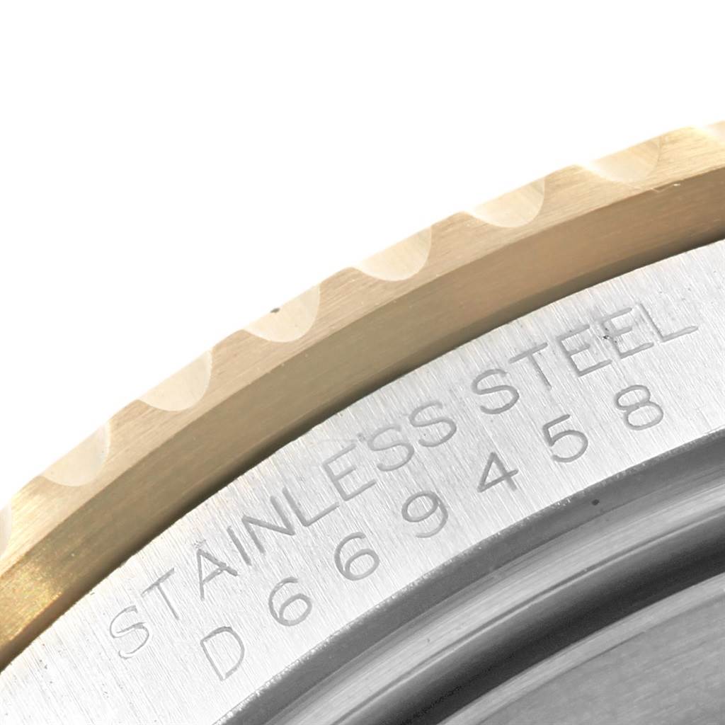 This close-up image of the Rolex GMT-Master 16713 Men
s Stainless Steel Black Dial 16713 Men
s Stainless Steel Black Dial shows the edge of the bezel and part of the serial number engraved on the stainless steel case.