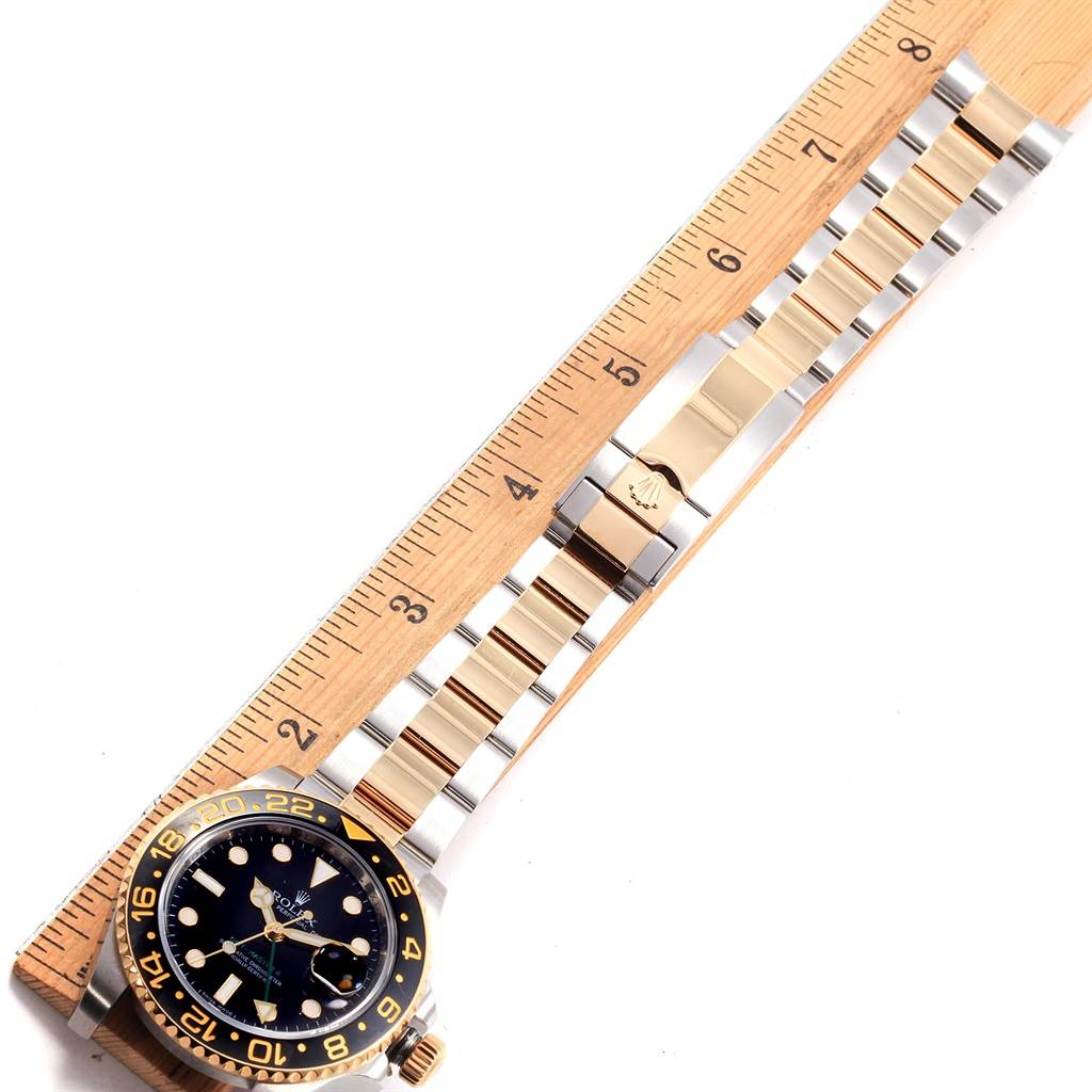 The image shows a top-down view of a Rolex GMT-Master 116713 Men's Stainless Steel Black Dial 116713 Men's Stainless Steel Black Dial watch alongside a ruler, highlighting its length and bracelet details.