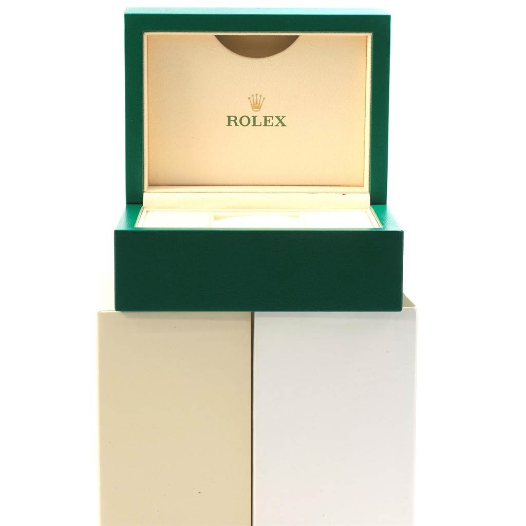 The image shows an open green Rolex box for the GMT-Master model, revealing the interior.