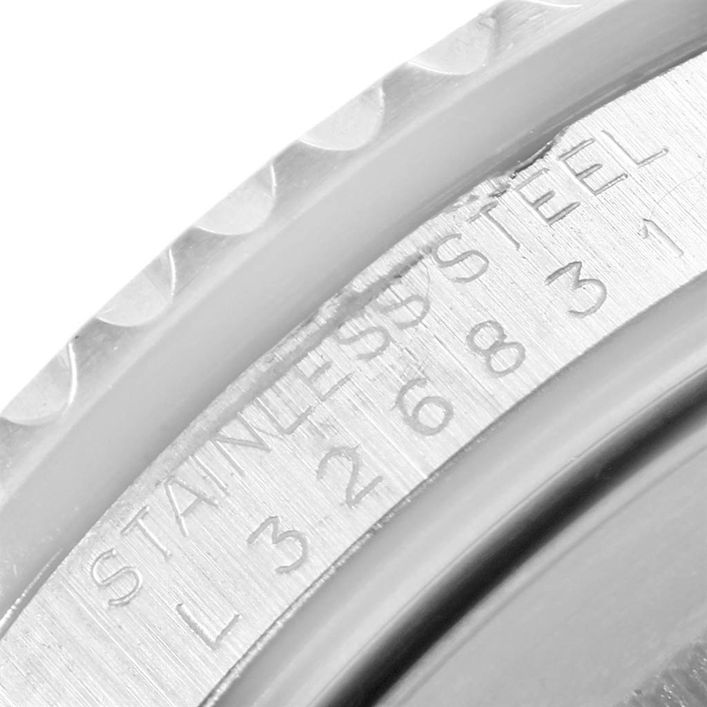 This image shows a close-up of the serial number engraving on the bezel of a Rolex GMT-Master 16710 Men's Stainless Steel Black Dial 16710 Men's Stainless Steel Black Dial watch.