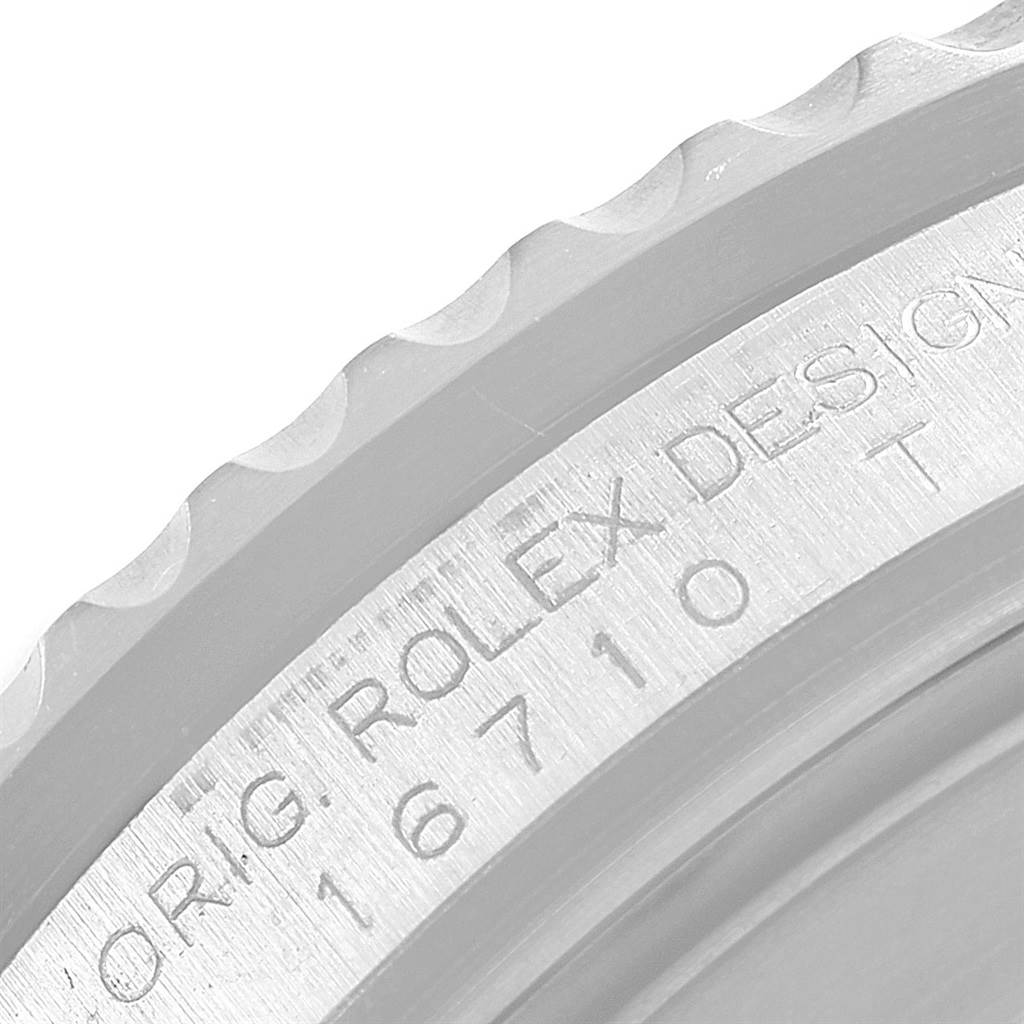 This image shows a close-up of the engraved bezel and serial number of a Rolex GMT-Master 16710 Men's Stainless Steel Black Dial 16710 Men's Stainless Steel Black Dial model.