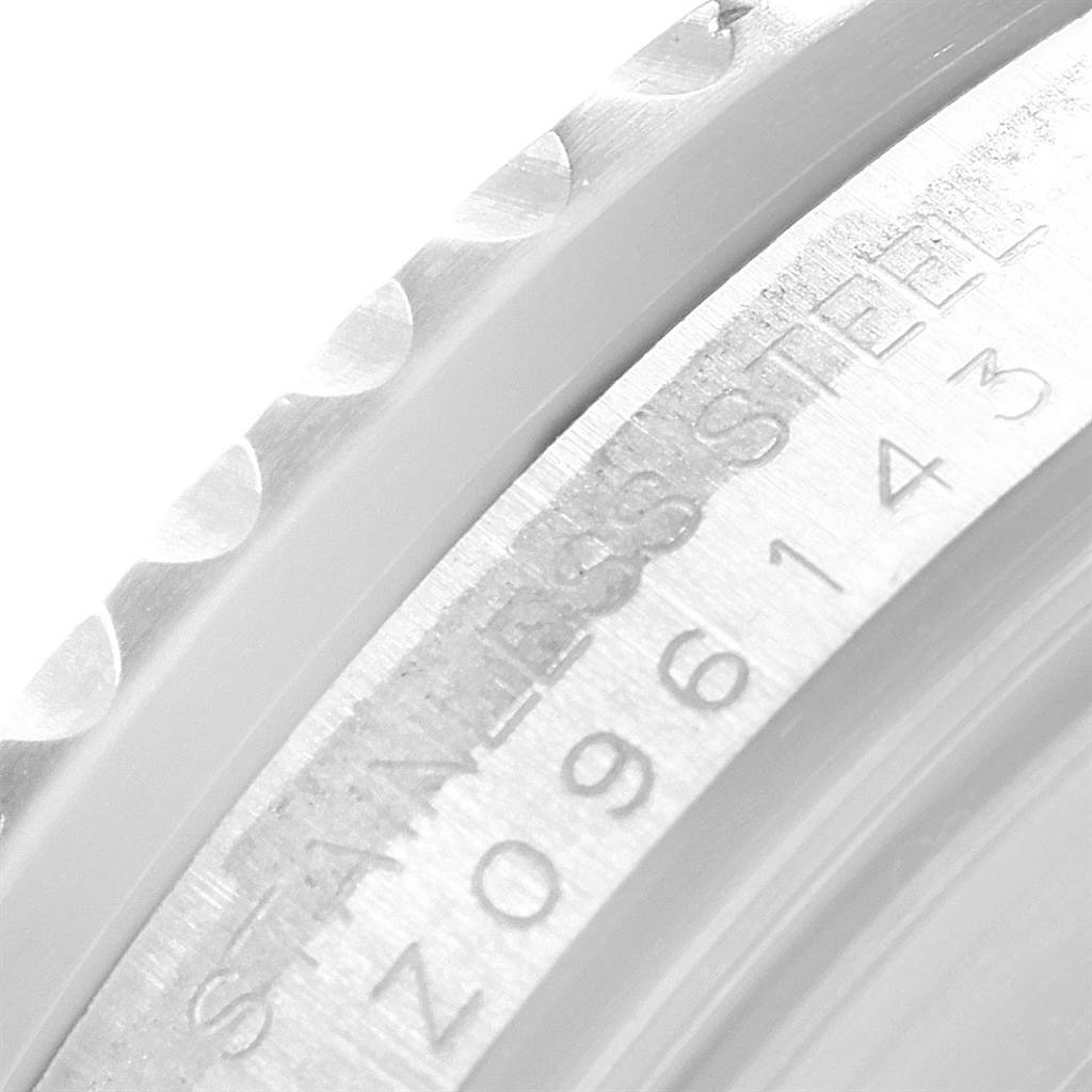 The image shows a close-up of the side of a Rolex GMT-Master 16710 Men's Stainless Steel Black Dial 16710 Men's Stainless Steel Black Dial watch, highlighting the stainless steel and serial number engravings.